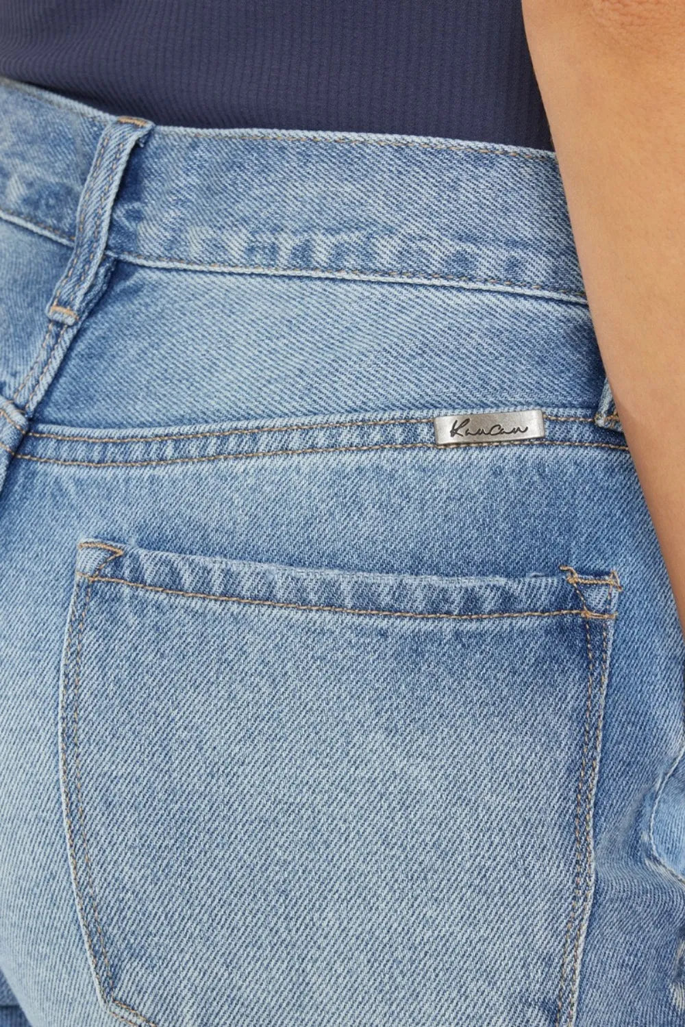 Kancan high waist chewed-up straight mom jeans with distressed details, styled on a model showcasing the trendy denim fit.