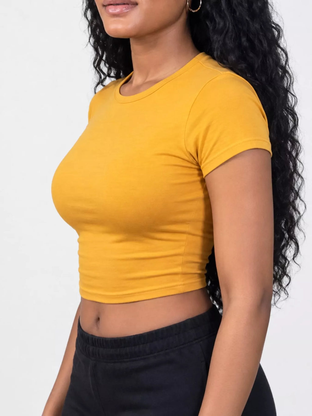 Slim fit basic crew neck short sleeve crop T-shirt by Trendsi, showing a stylish white crop top with a fitted silhouette.