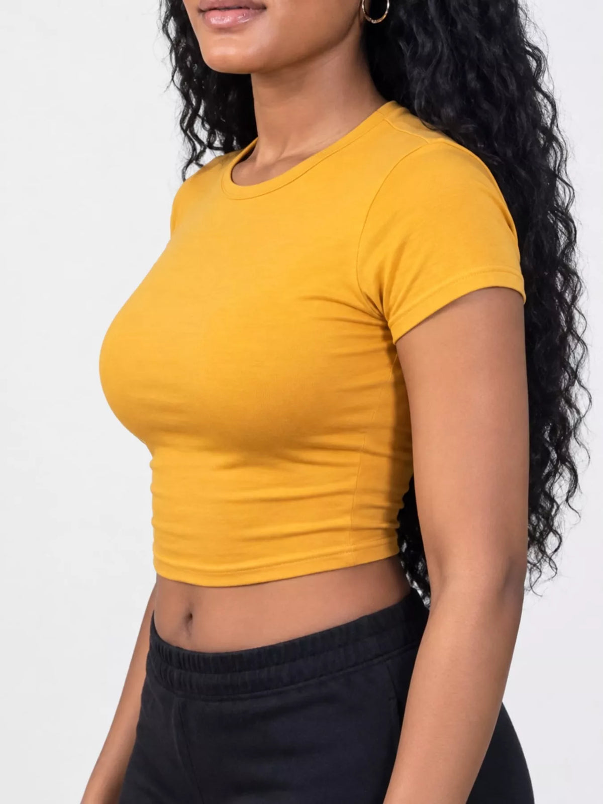 Slim fit basic crew neck short sleeve crop T-shirt by Trendsi, showing a stylish white crop top with a fitted silhouette.