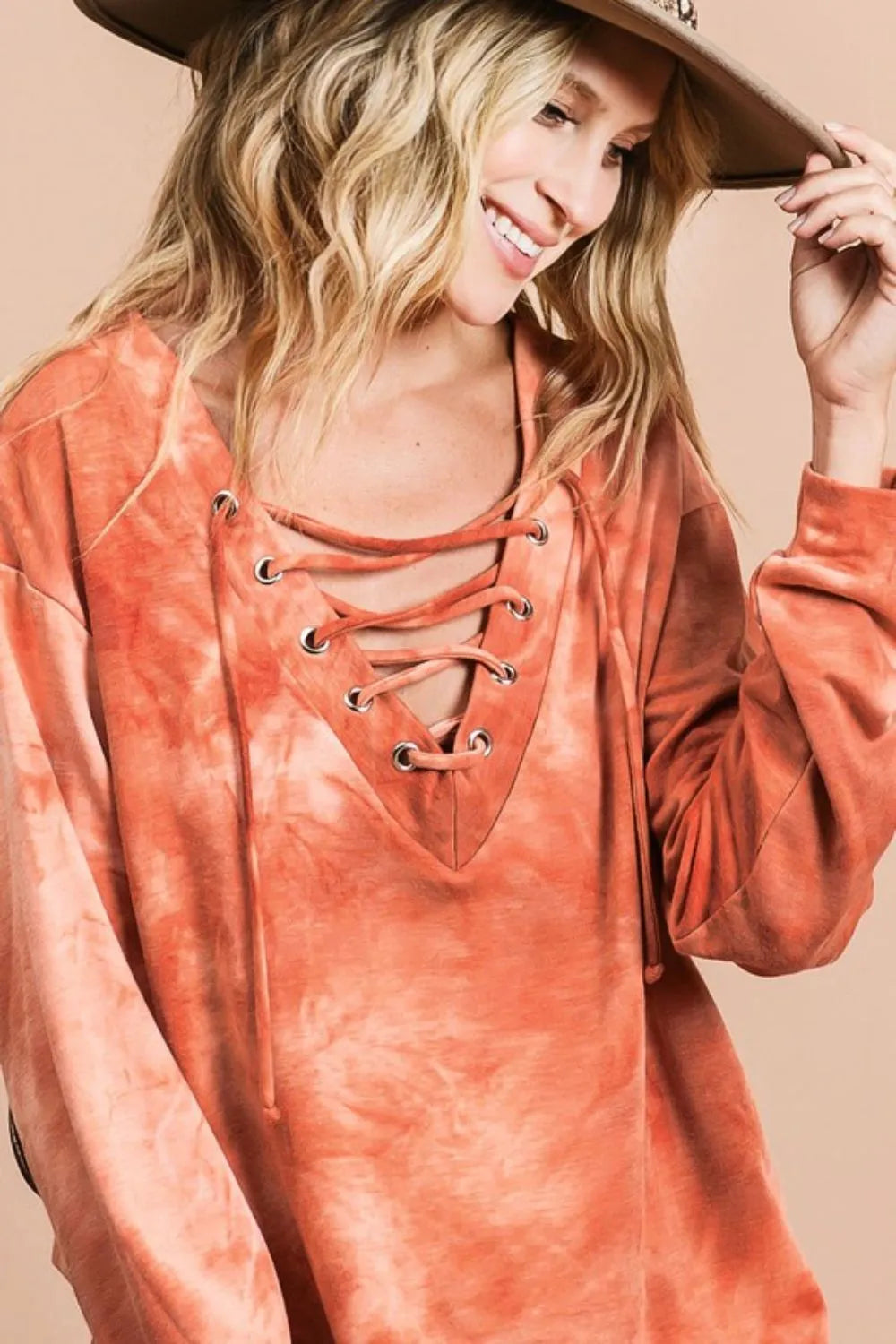 BiBi Lace-Up Tie-Dye French Terry Long Sleeve Top featuring a relaxed fit, vibrant tie-dye pattern, and lace-up neckline from Trendsi.