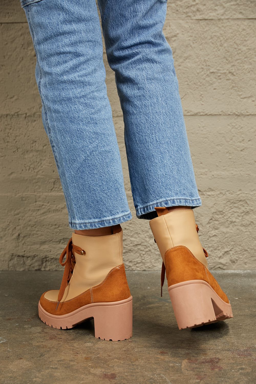 East Lion Corp lace-up lug booties with chunky soles, featuring black leather material and sturdy design for trendy winter footwear.