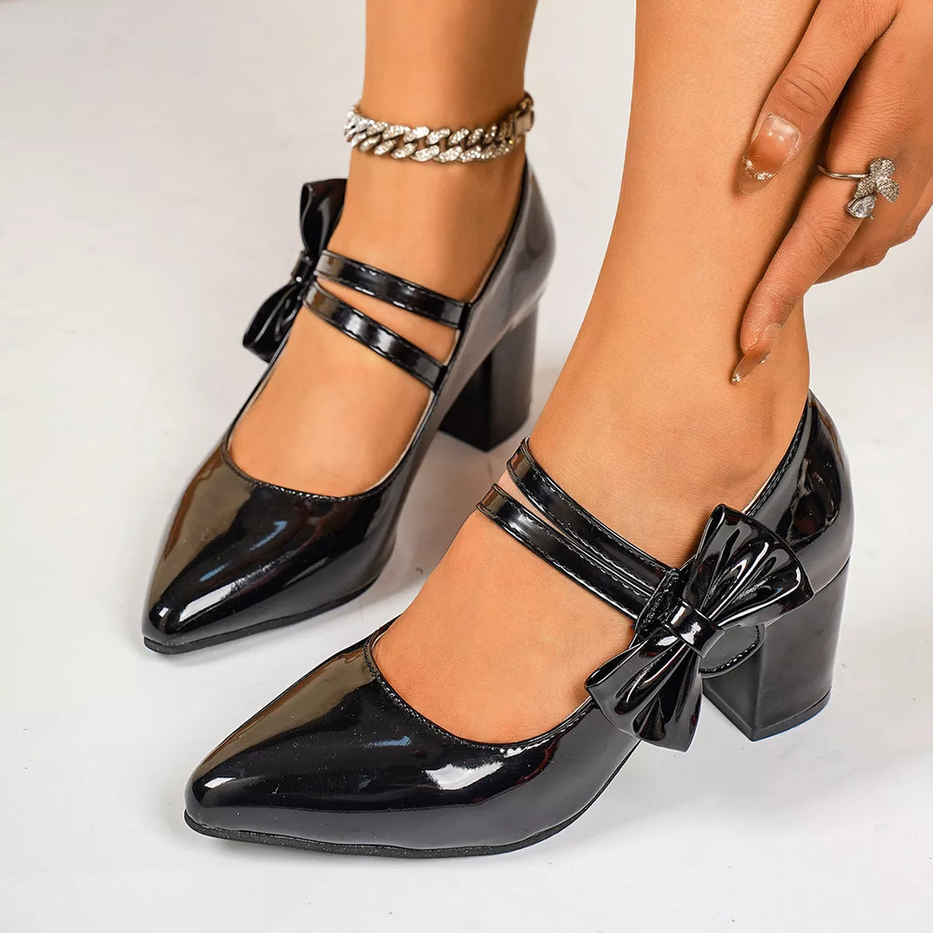 Point toe block heel pumps by Trendsi featuring sleek black leather with a stylish pointed toe design.