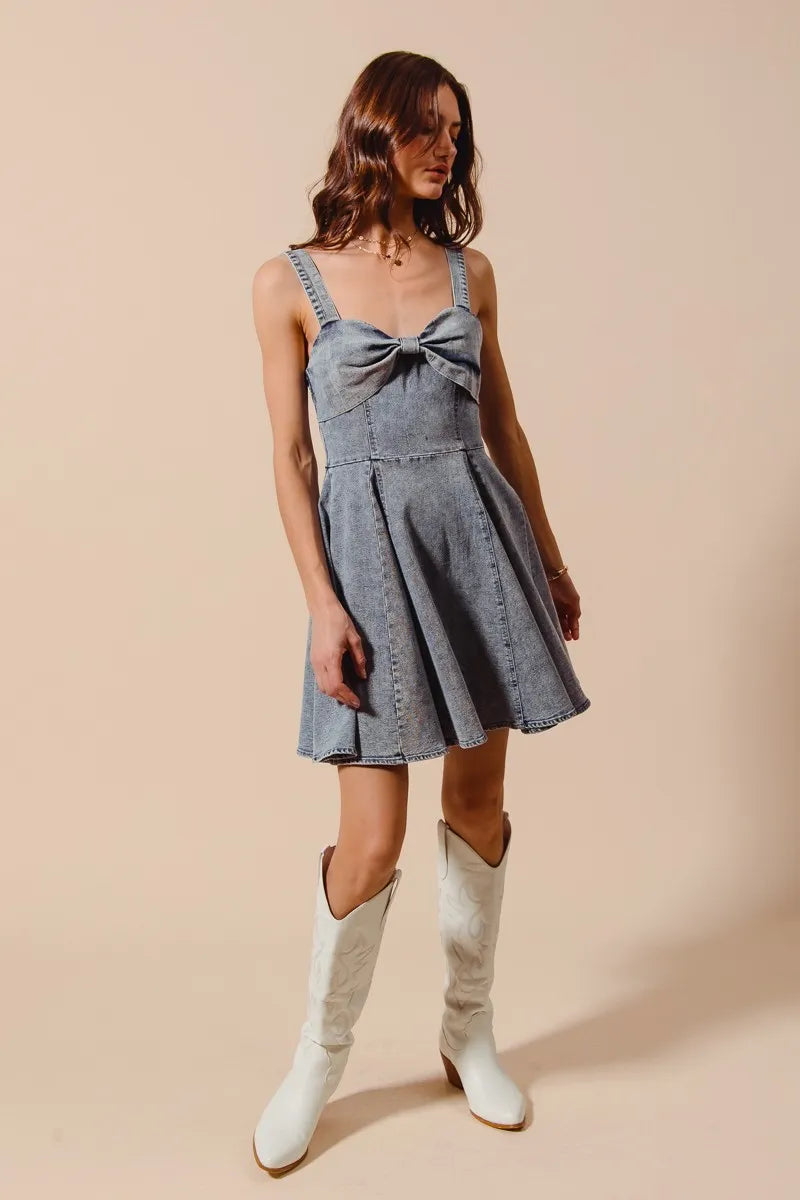 Mineral washed bow ribbon denim flare dress by Trendsi featuring a fit-and-flare style and bow detail at the waist.