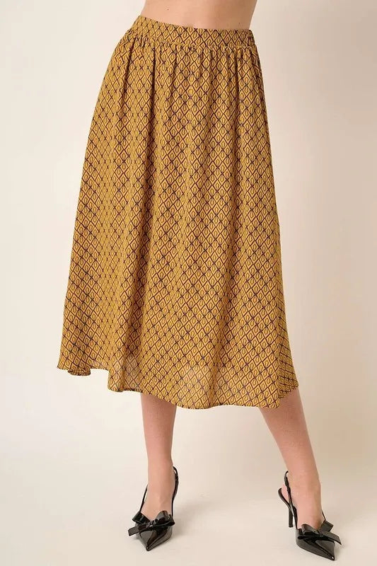 Printed midi skirt from Mittoshop by Trendsi featuring a stylish pattern and flowy design, shown on a model.