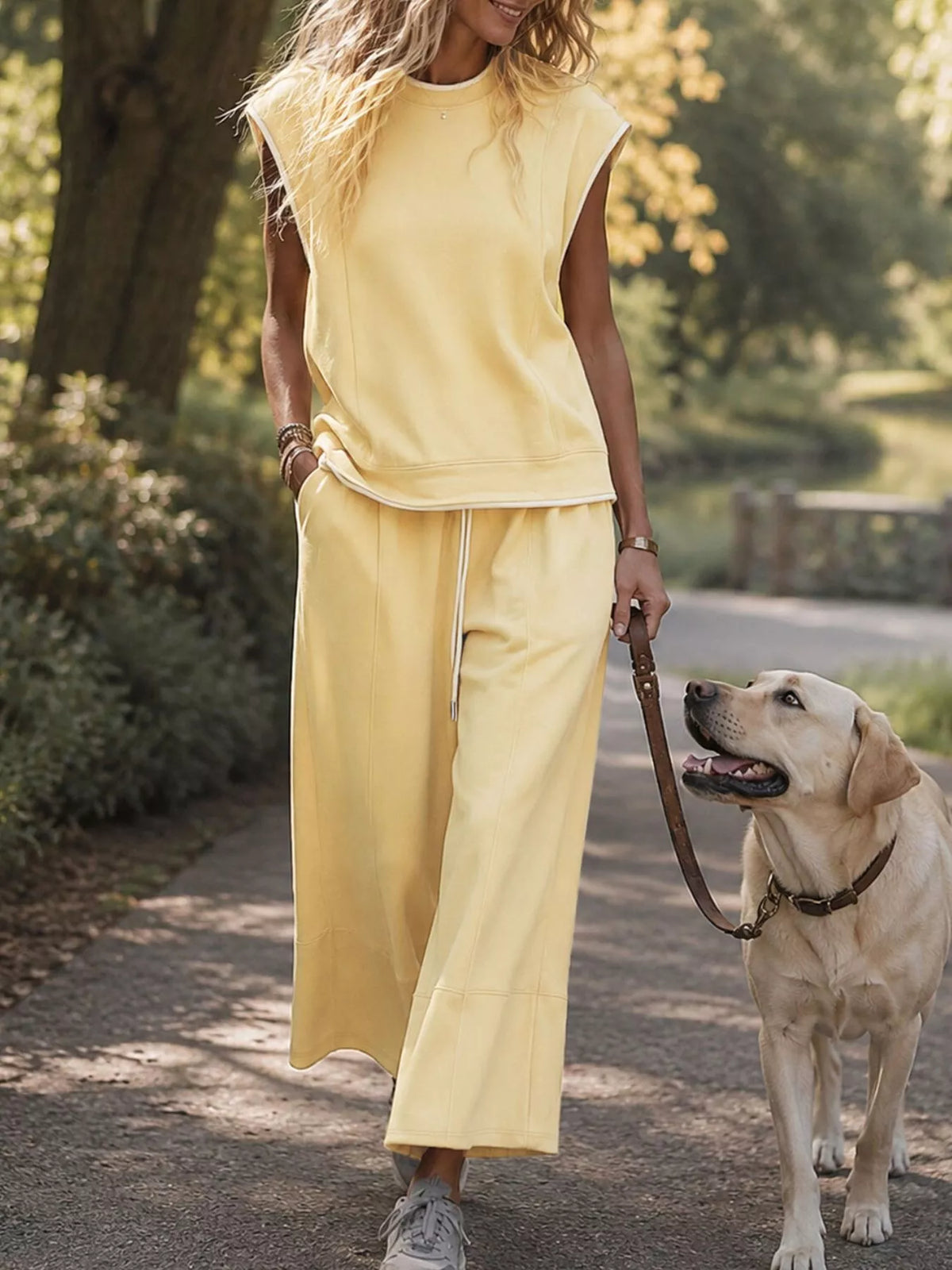Sleeveless crew neck top and wide-leg cropped pants set by Trendsi, featuring a stylish, coordinated outfit with a modern fit.