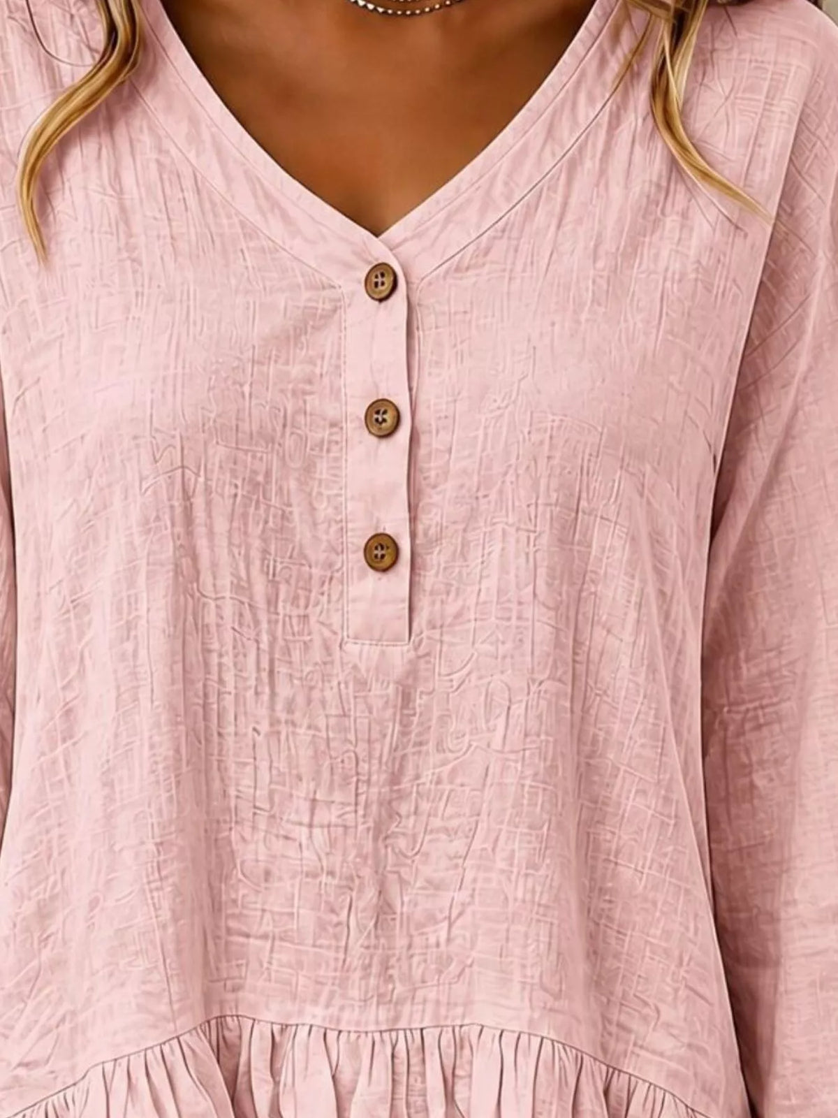 Long sleeve blouse with ruffled hem from Trendsi, featuring a feminine design and soft fabric, shown on a model.
