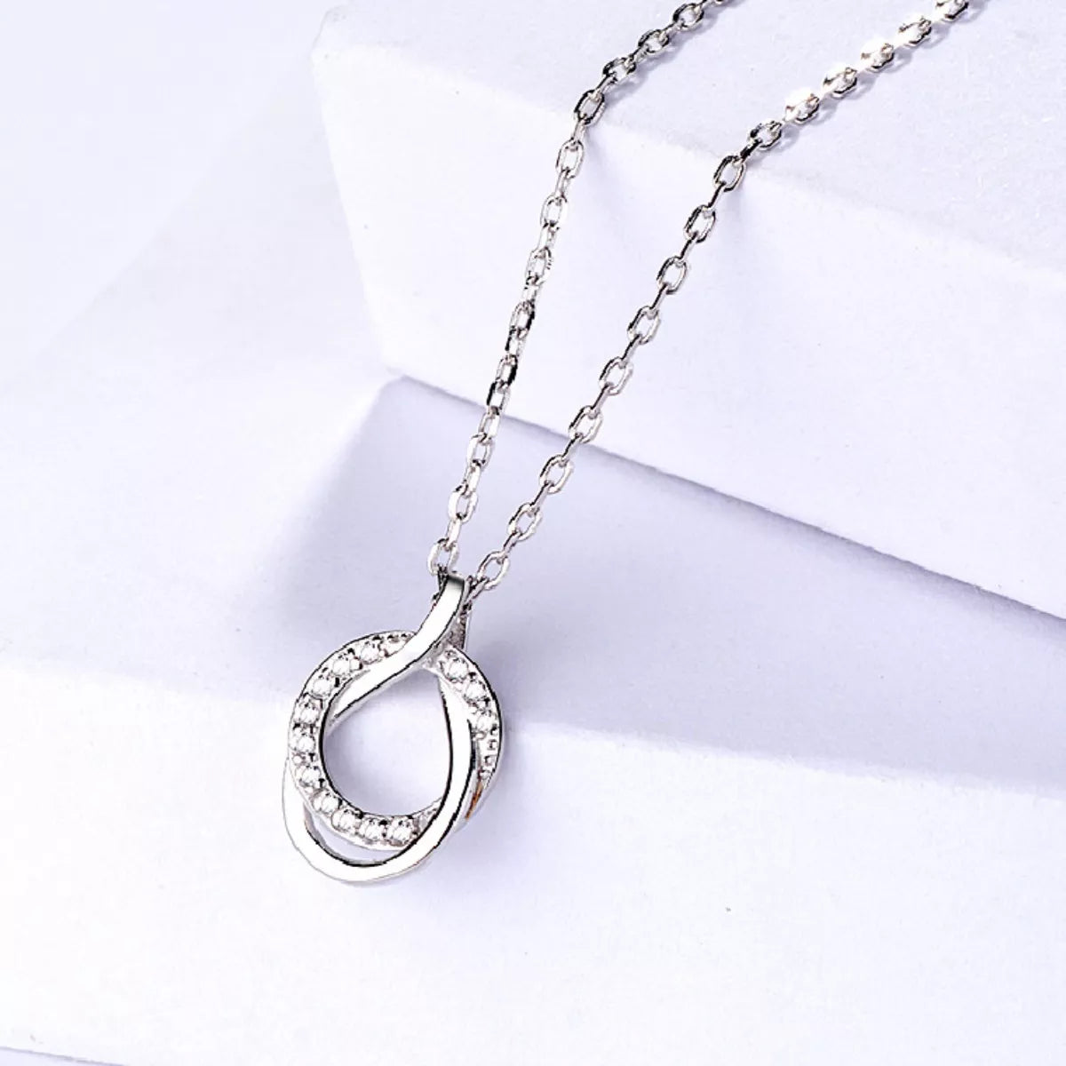 Sterling silver zircon pendant necklace with a delicate, sparkling gemstone design, perfect for elegant jewelry styling.