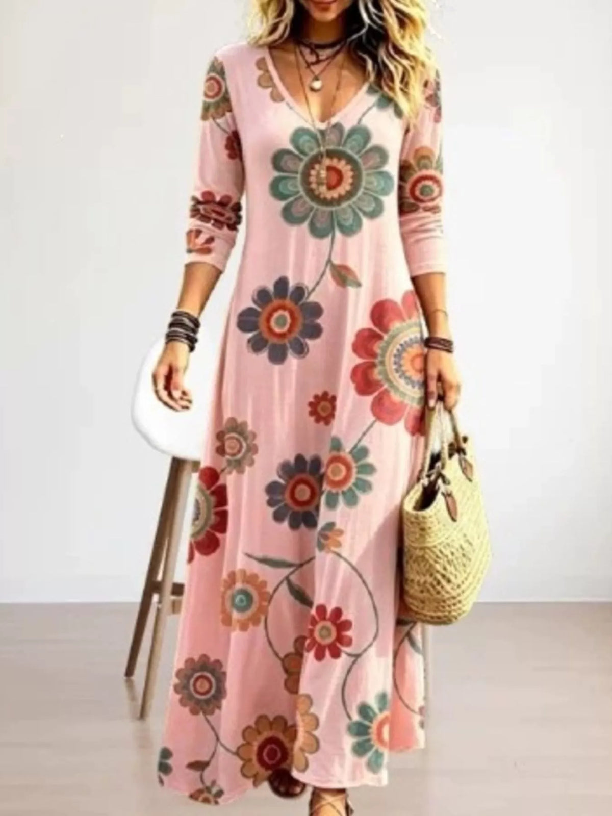 Floral print V-neck long sleeve maxi dress by Trendsi, featuring a flowing silhouette and vibrant floral pattern.