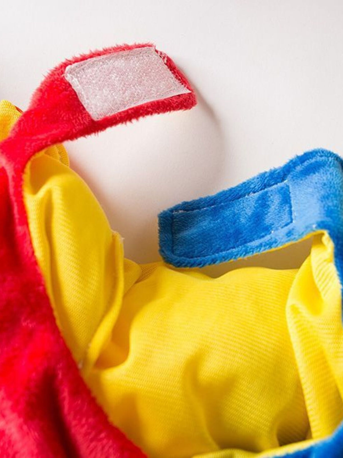 Colorful clown pet jumpsuit with hat, featuring bright patterns and adjustable fit, perfect for playful pet costumes.
