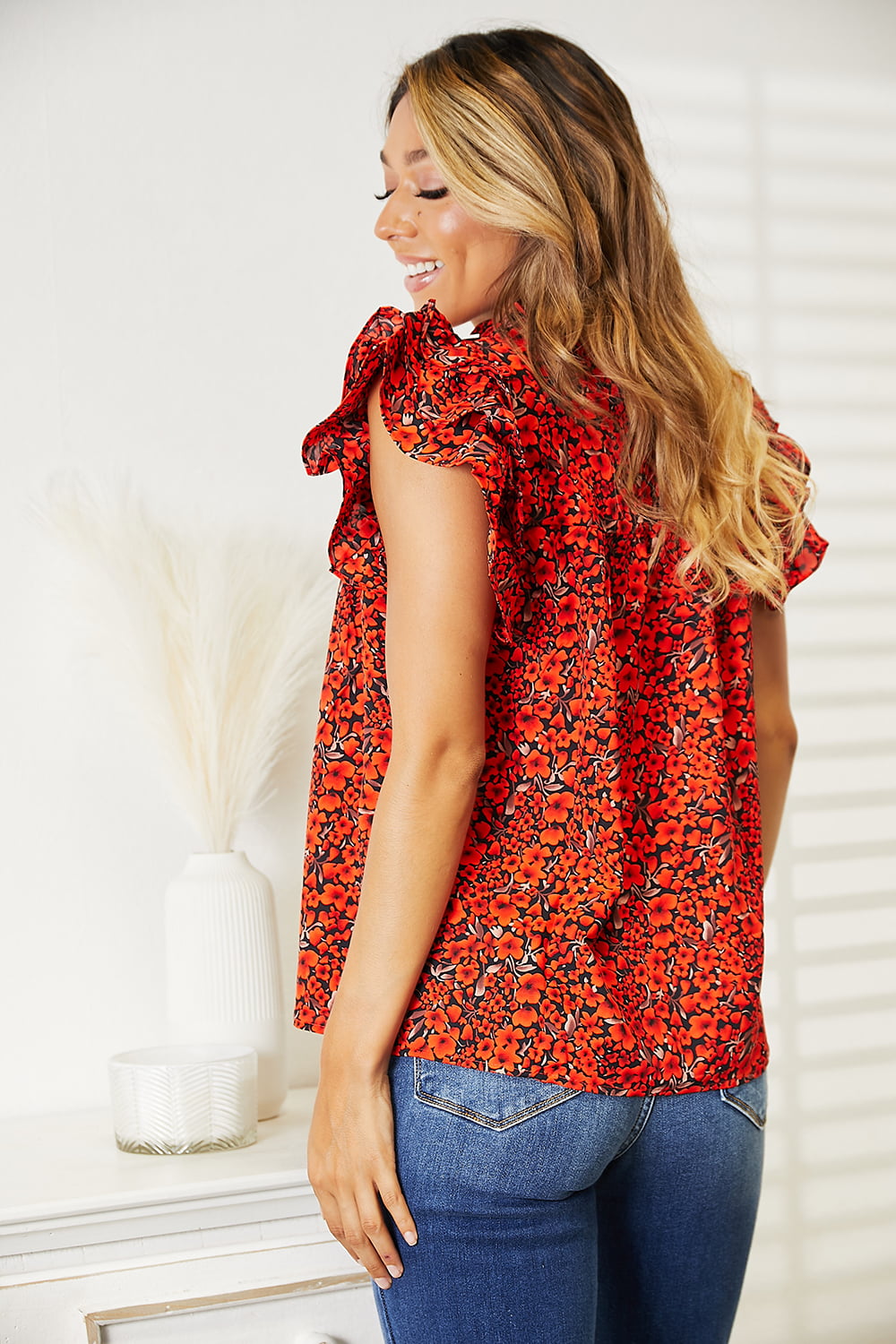 Floral flutter sleeve blouse with notched neckline from Trendsi, featuring lightweight fabric and feminine design.