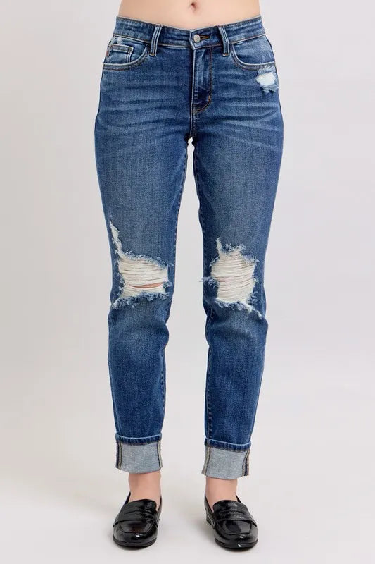 Plus size Judy Blue boyfriend jeans with mid-rise, distressed details, yoke pockets, and faux selvedge cuff for a casual look.