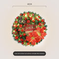Green Christmas wreath with red letters and flowers