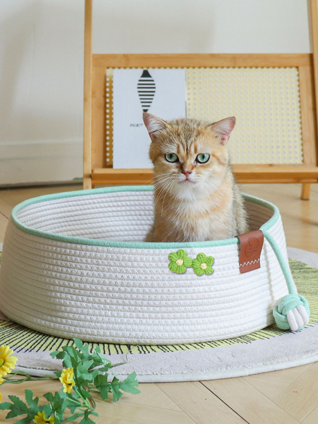 Woven pet nest with soft interior and attached toy ball, designed for small pets, by Trendsi.