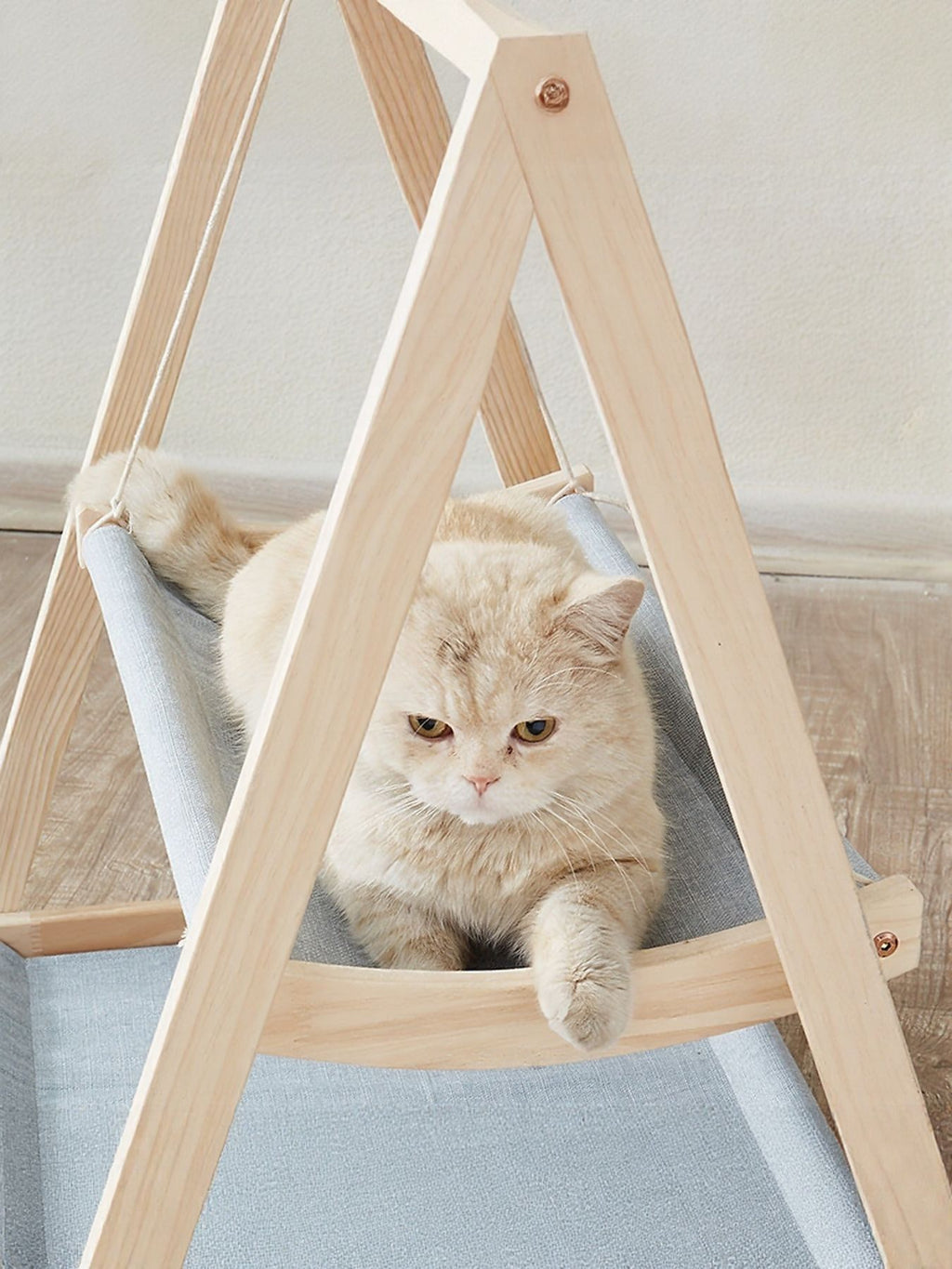 Wooden triangle cat hammock by Trendsi, featuring a cozy fabric resting area suspended between wooden frames for feline comfort.