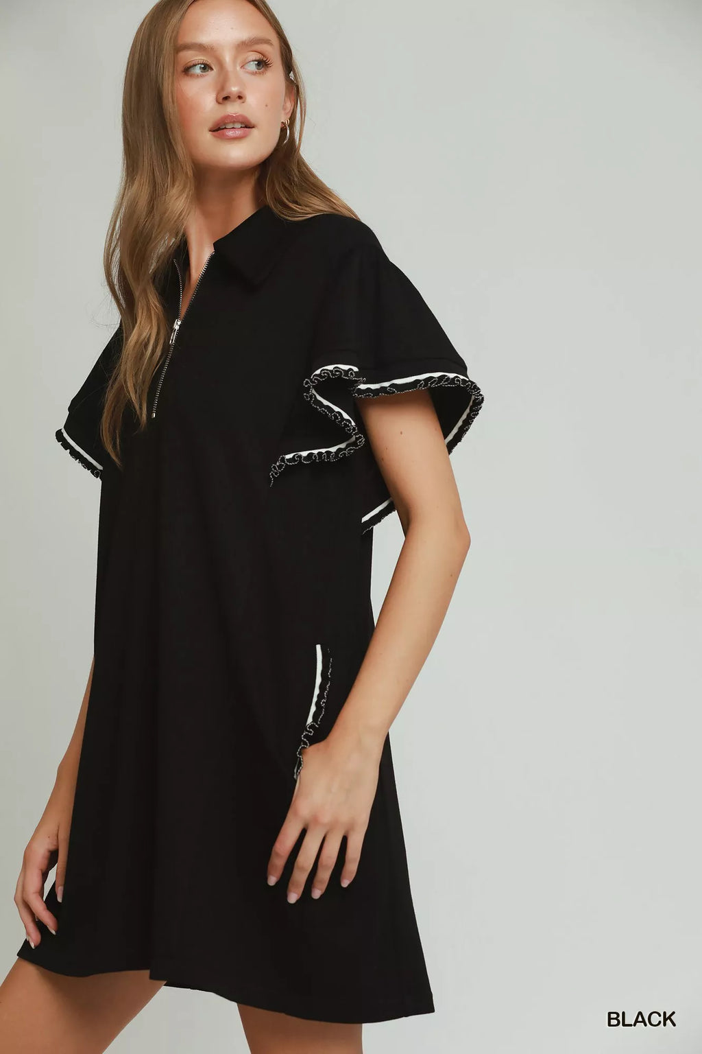 Umgee mini dress with half zip, ruffle rib band, butterfly sleeves, and pockets, featuring a stylish and casual design.
