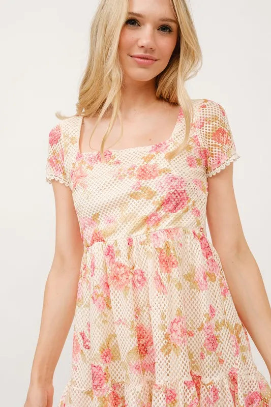Square neck tiered floral fishnet dress by Trendsi featuring a feminine floral pattern and layered design.