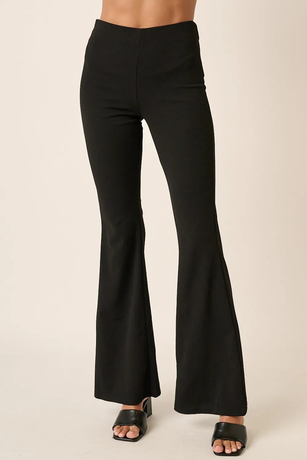 Crepe knit flare leg pants with elastic waist by Mittoshop, featuring a fitted top and wide-leg silhouette in black.
