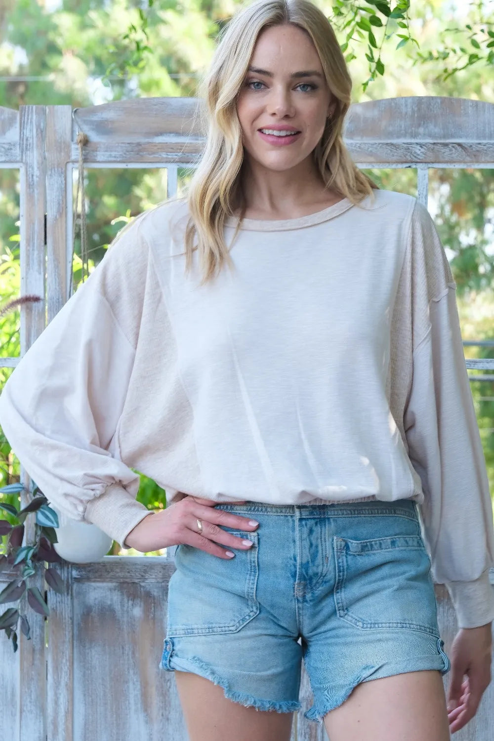 Hailey & Co ribbed and two-tone knit mixed top in beige and brown with long sleeves, casual style, on a model.