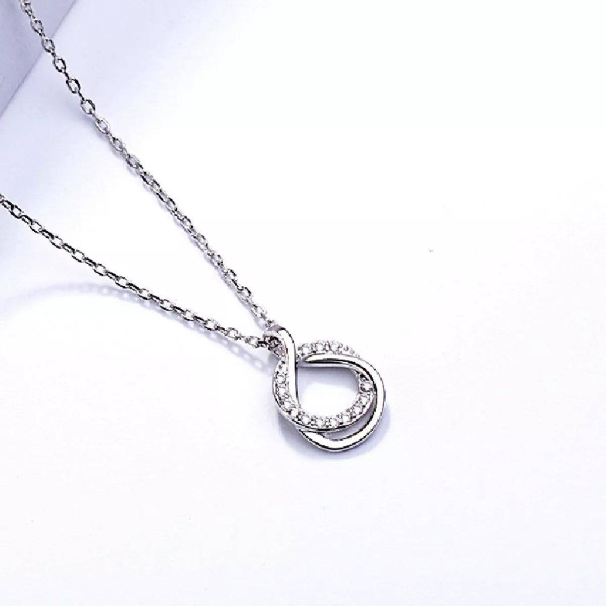 Sterling silver zircon pendant necklace with a sparkling gemstone, elegant jewelry piece on a delicate chain.