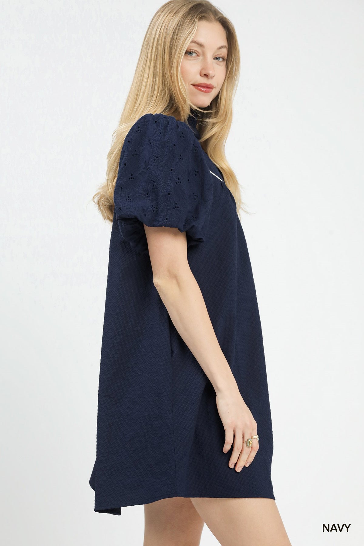 Umgee puff sleeve textured babydoll dress with a flowing fit, featuring a round neckline and feminine silhouette.