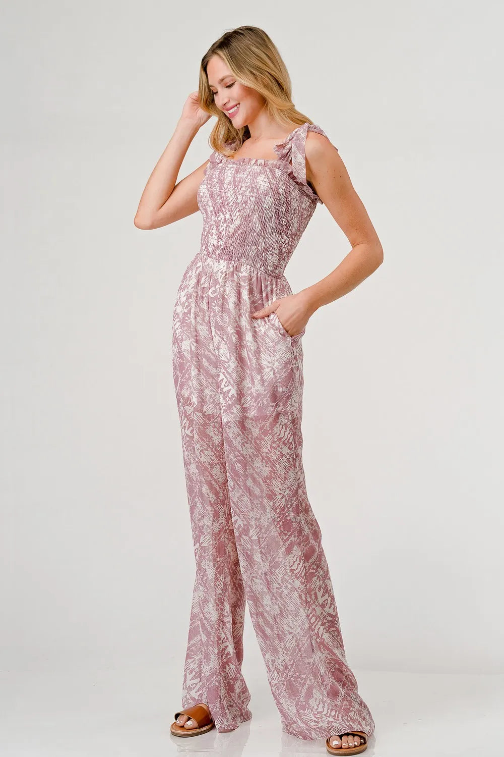Printed tie-shoulder wide-leg jumpsuit by Trendsi featuring a stylish design and relaxed fit, perfect for casual or summer wear.