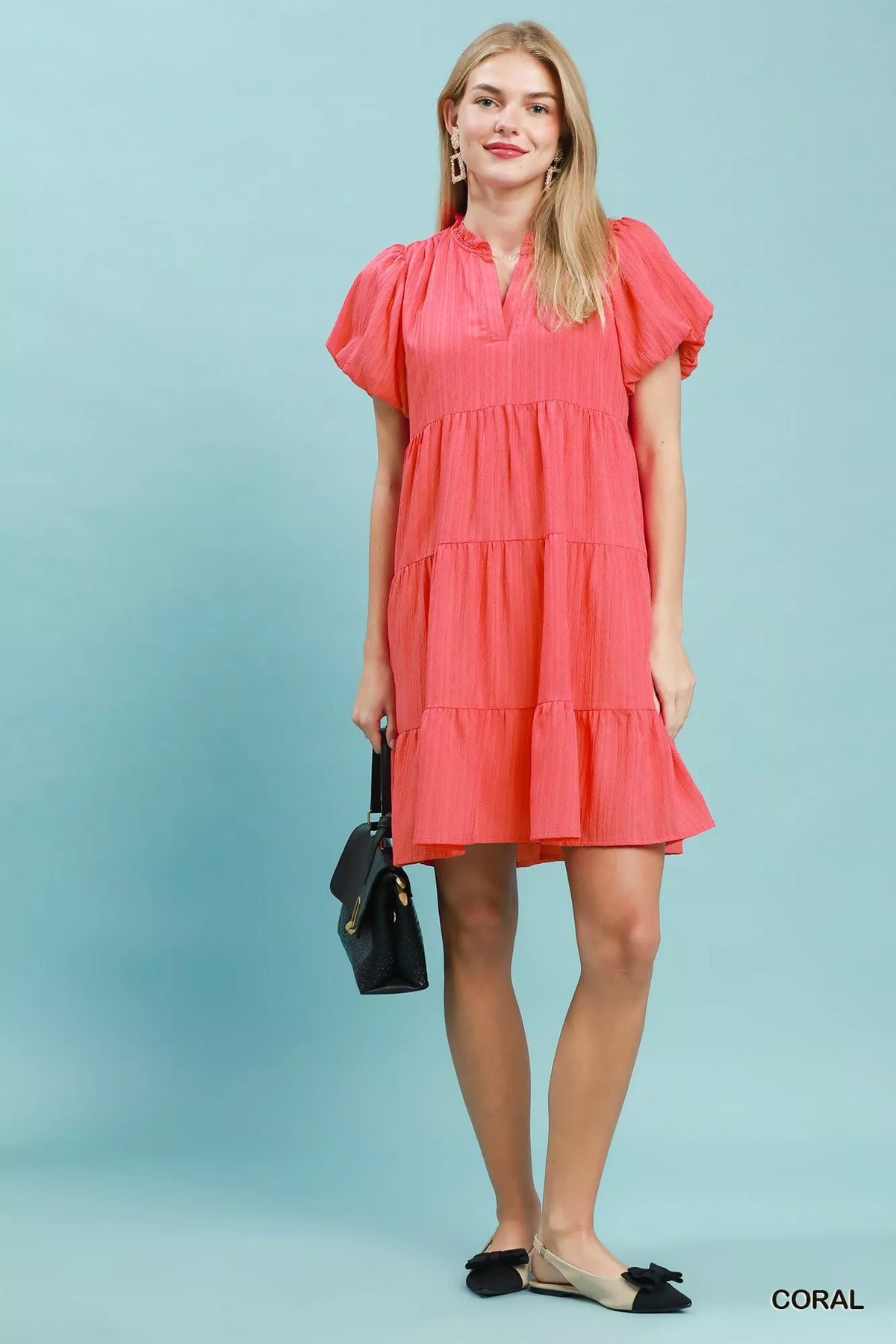 Umgee puff sleeve tiered babydoll dress in lightweight fabric with ruffled sleeves and a flowing, feminine silhouette.