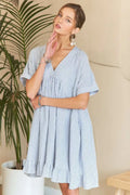 Striped ADORA Ruffled Hem V-Neck Babydoll Dress by Trendsi, featuring a flowy silhouette and ruffled hem detail.