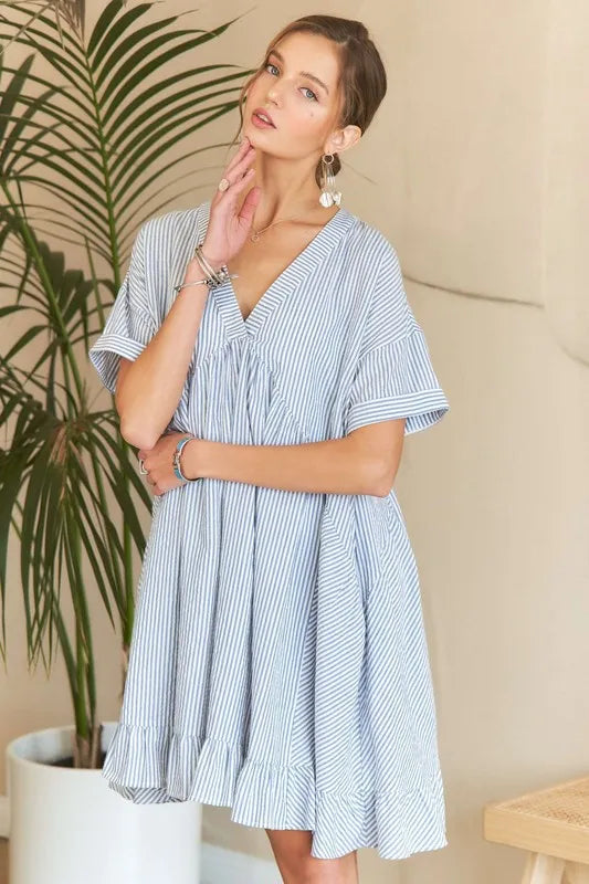 Striped ADORA Ruffled Hem V-Neck Babydoll Dress by Trendsi, featuring a flowy silhouette and ruffled hem detail.
