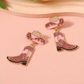 Sparkling rhinestone boot dangle earrings by Trendsi featuring detailed silver-toned design and hanging boot charm.