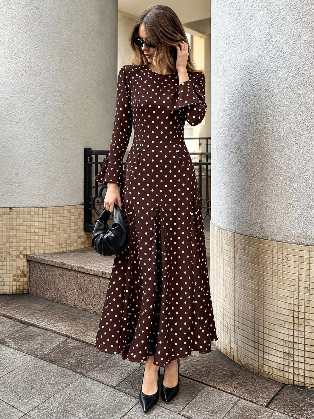 Polka dot long sleeve maxi dress by Trendsi featuring a flowing design and classic pattern, ideal for elegant daytime wear.
