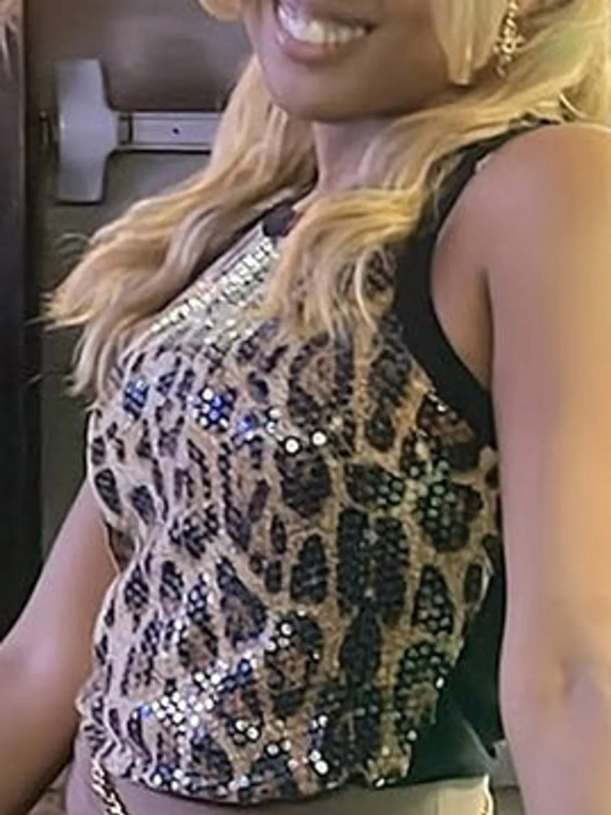 Sequin round neck tank top by Trendsi featuring shimmering sequins and a classic round neckline, displayed on a model.
