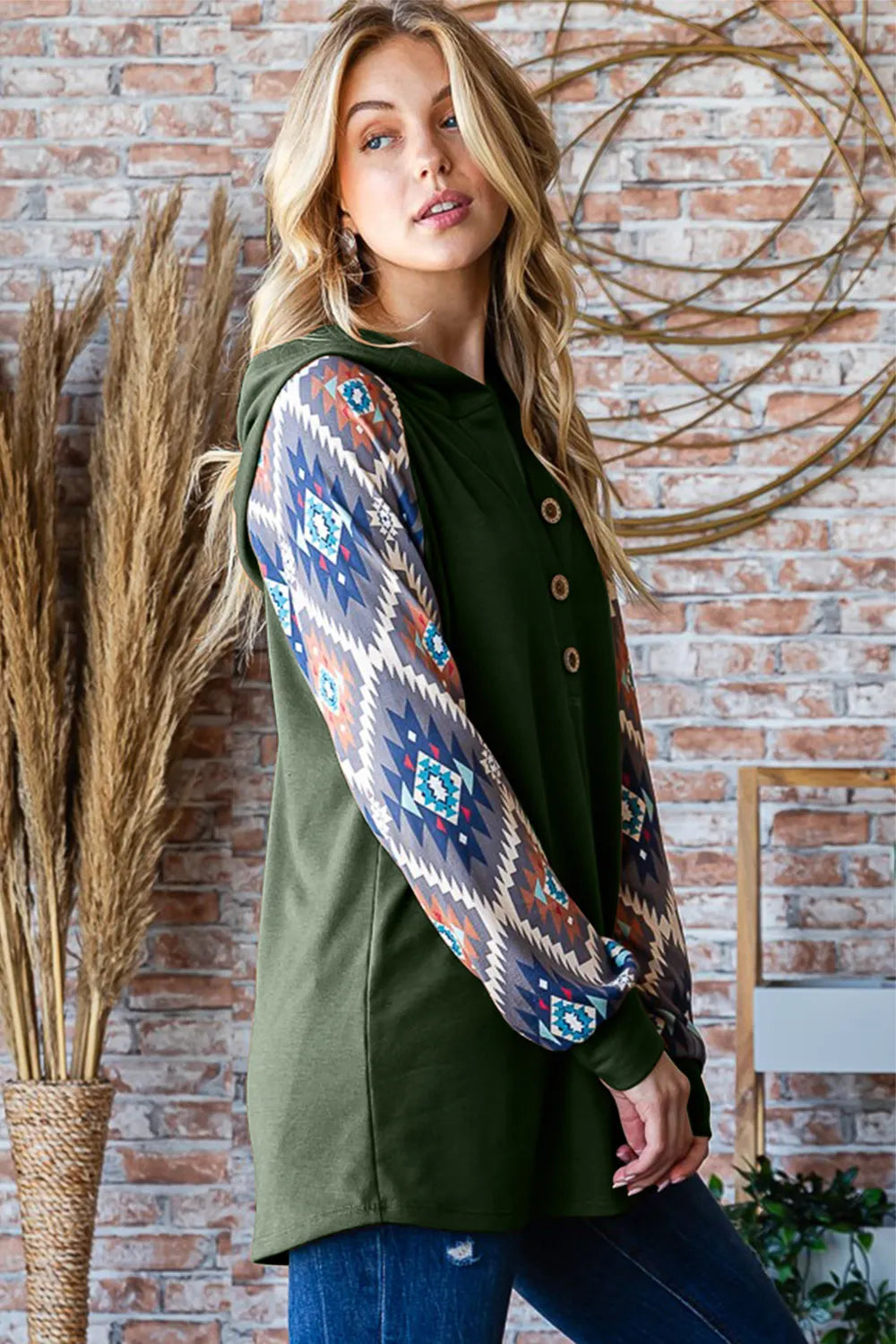 Heimish full size long sleeve hooded top with half button print, featuring a casual design and a comfortable fit.