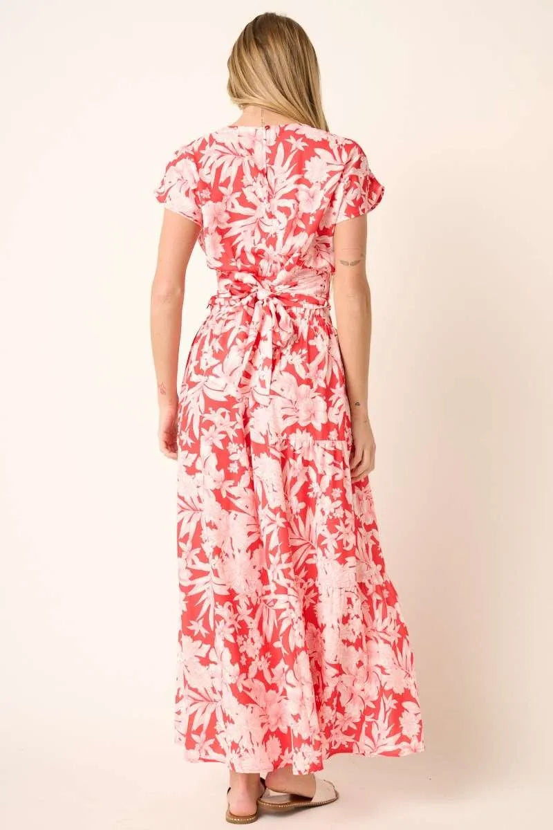 Tropical print top and skirt set by Trendsi featuring vibrant floral patterns and lightweight fabric for a summery look.