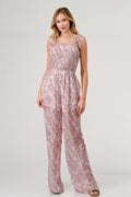 Printed tie-shoulder wide-leg jumpsuit by Trendsi, featuring a stylish design with a comfortable fit and trendy details.