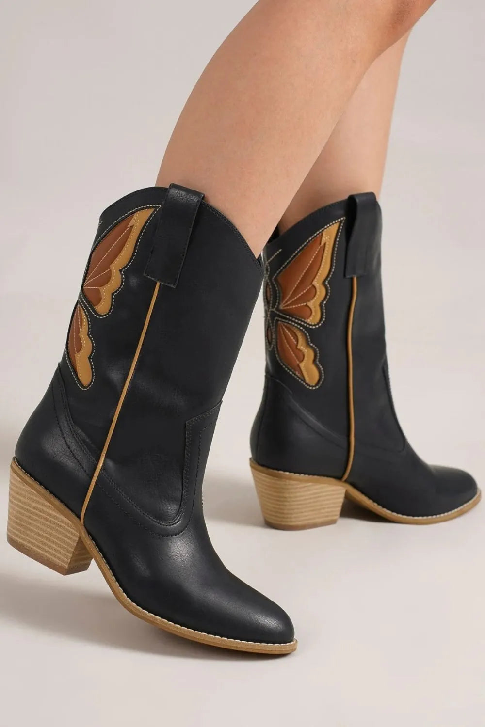 Trendsi Beast Fashion butterfly cut detail point toe boots with stylish butterfly accents and sleek design.