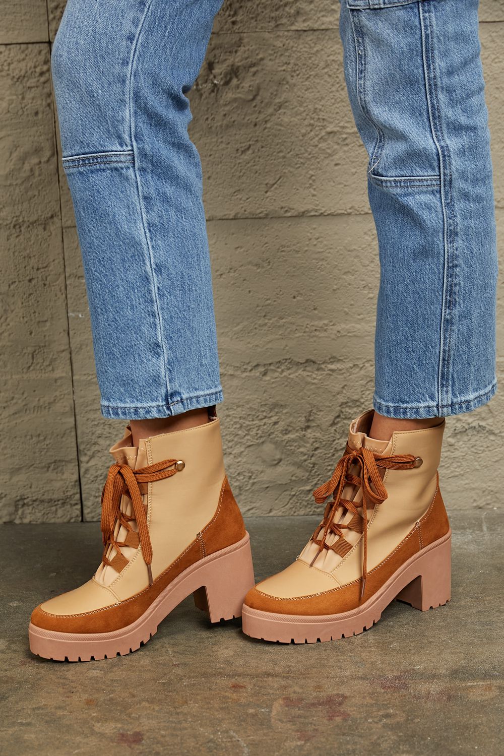 East Lion Corp lace-up lug booties with chunky soles and leather finish, stylish ankle boots for trendy winter wear.