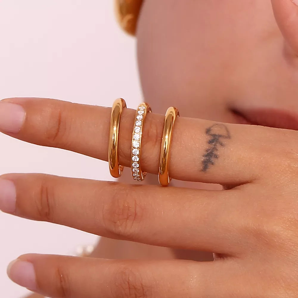 Three-piece stainless steel zircon ring set featuring shiny silver bands, perfect for stylish everyday jewelry.