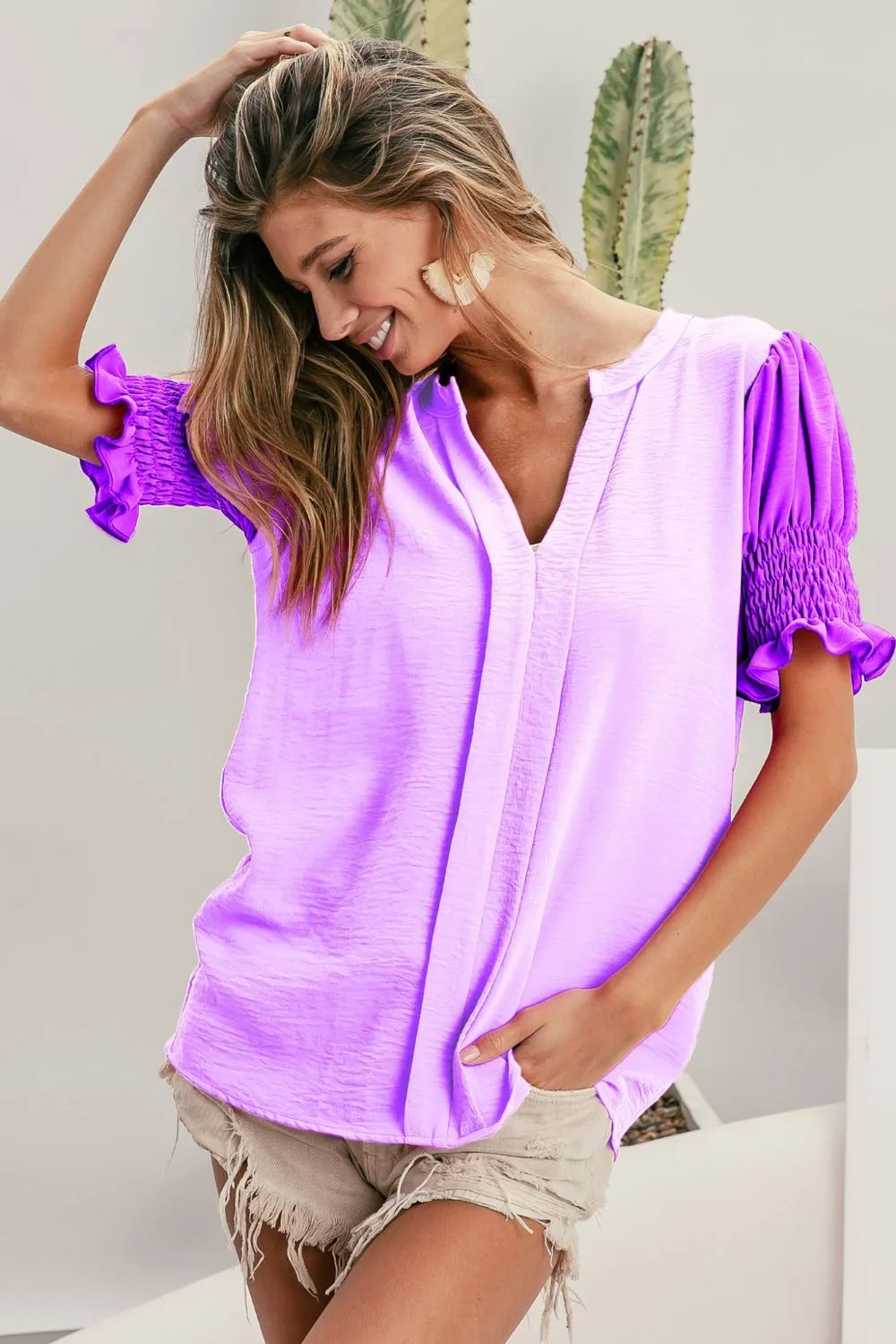 Color block puff sleeves V-neck top by Trendsi featuring a flowy design and vibrant color accents on soft fabric.