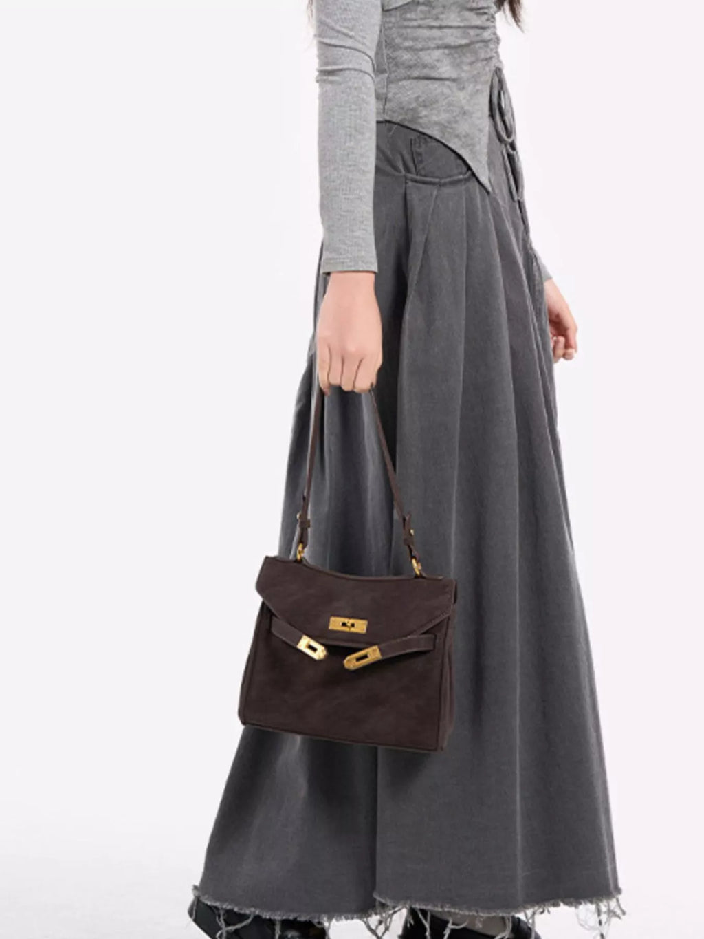 Gold-tone hardware crossbody bag with sleek design and adjustable strap, featuring trendy style and compact size.