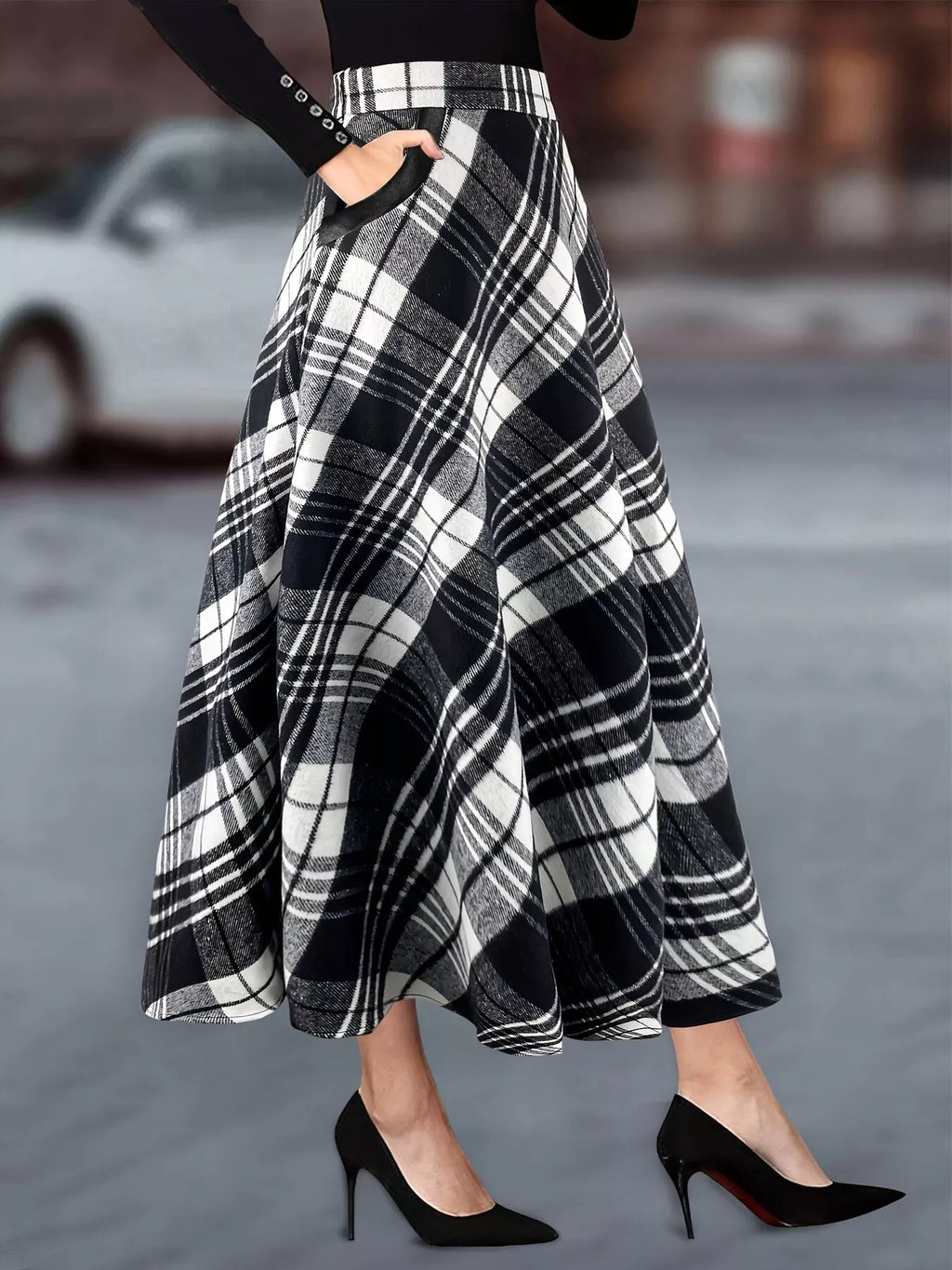 Plaid A-line midi skirt with pockets by Trendsi, featuring a stylish checkered pattern and a flowy silhouette.