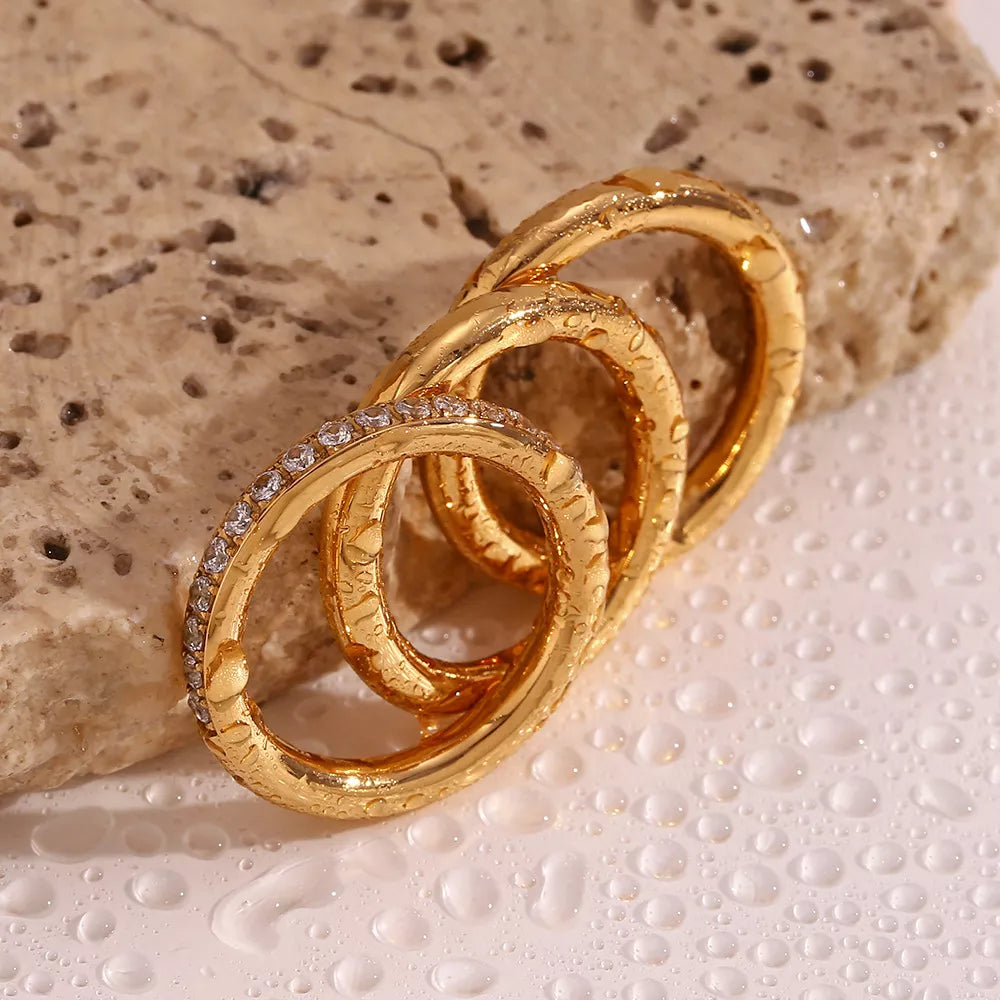 Three stainless steel zircon rings in a set, featuring sleek designs and sparkling accents, ideal for everyday or special occasions.