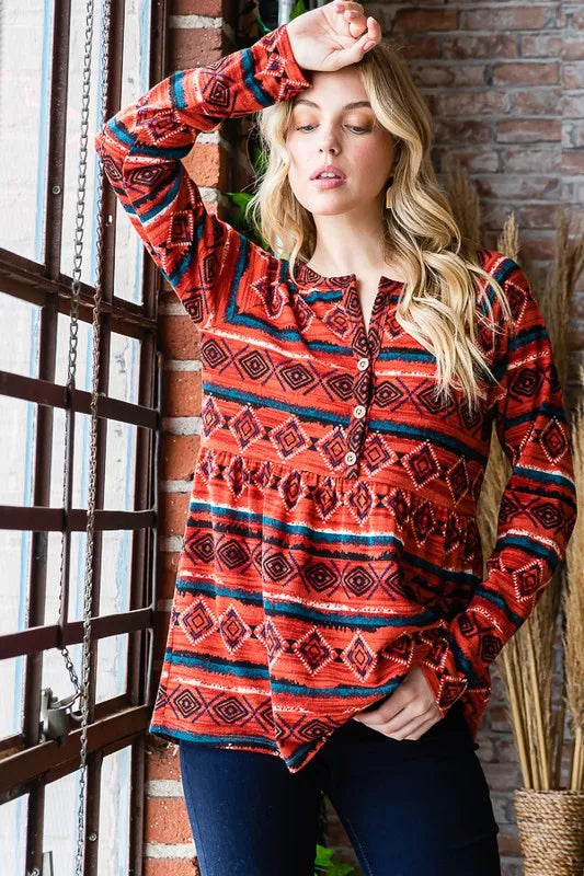 Heimish full size long sleeve babydoll top with geometric button details, featuring a stylish, flowy silhouette and feminine design.