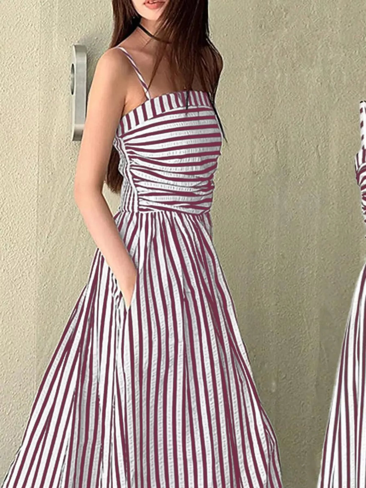 Striped spaghetti strap A-line maxi dress by Trendsi, featuring a flowy silhouette and colorful vertical stripe pattern.
