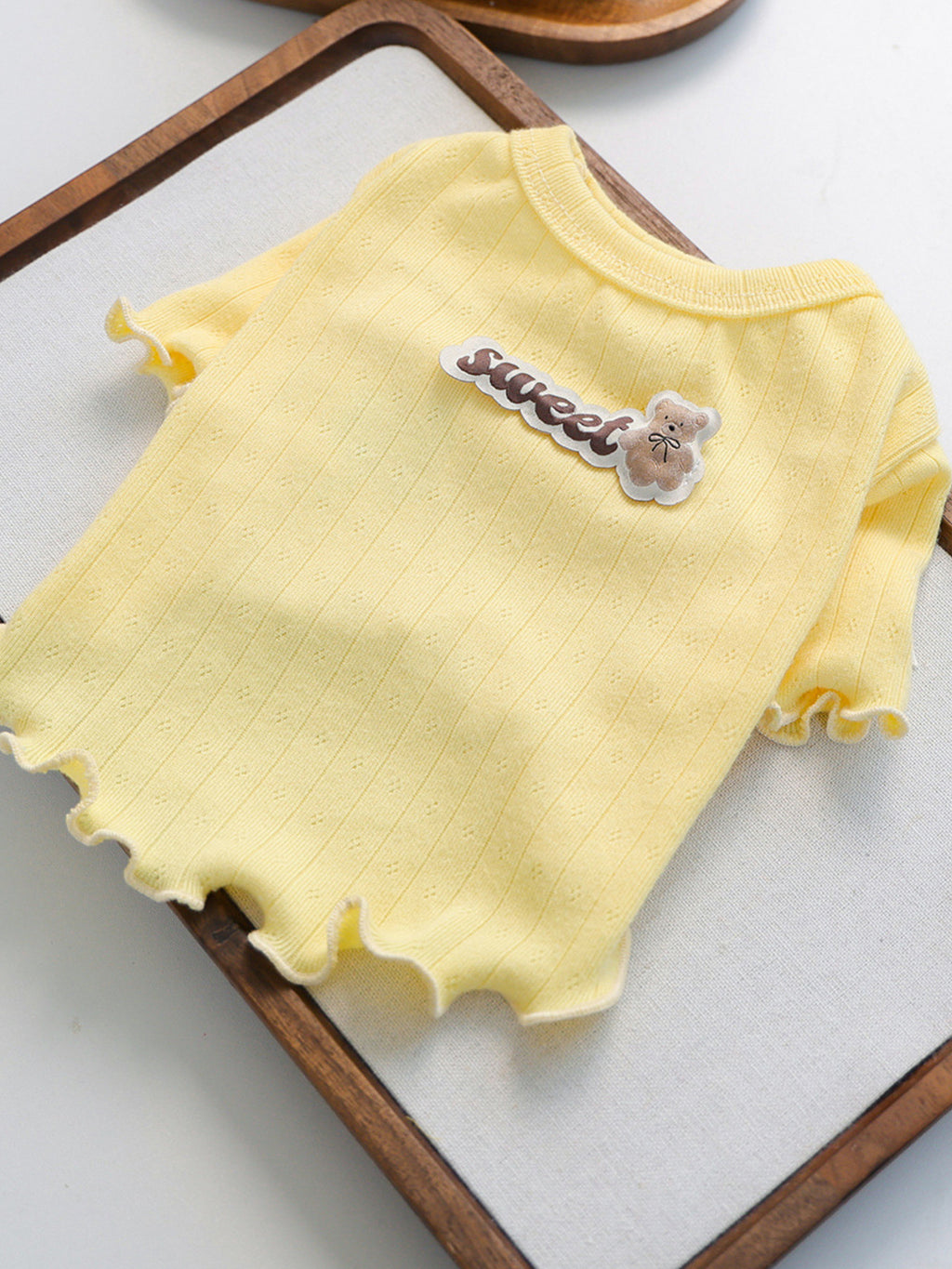 Ribbed pink pet top with sweet bear patch by Trendsi, featuring a snug fit and cozy design for small dogs or cats.