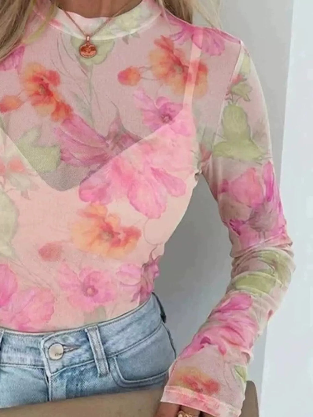 Plus size floral print sheer mesh long sleeve t-shirt by Trendsi, showcasing a vibrant floral pattern and lightweight, breathable fabric.