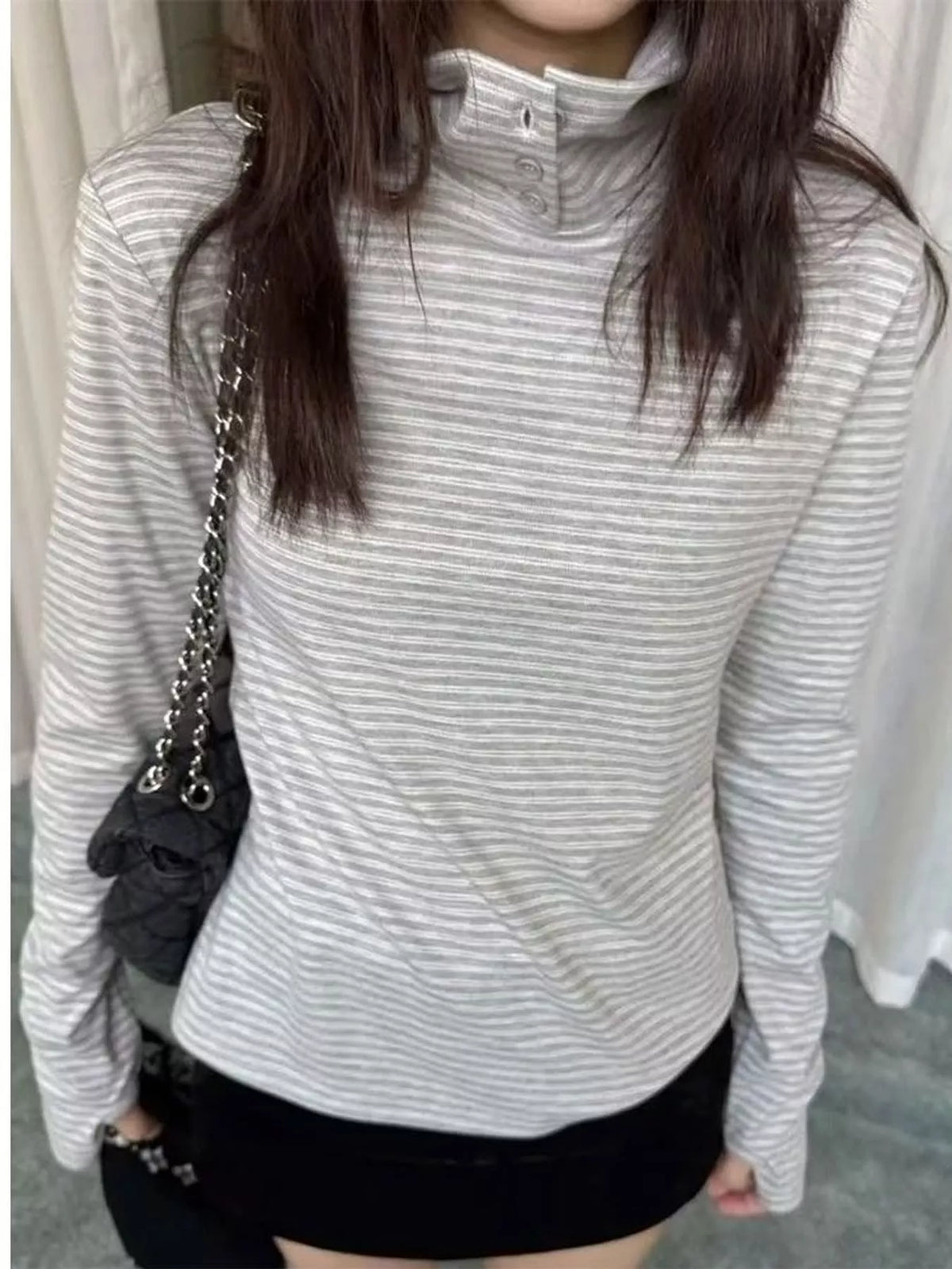 Striped mock neck long sleeve T-shirt with button details, stylish casual top by Trendsi, featuring a fitted design and contrasting stripe pattern.