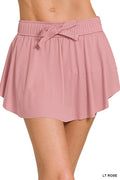Zenana tennis skirt with ruffle hem and hidden inner pockets, stylish activewear skirt in a sleek design.