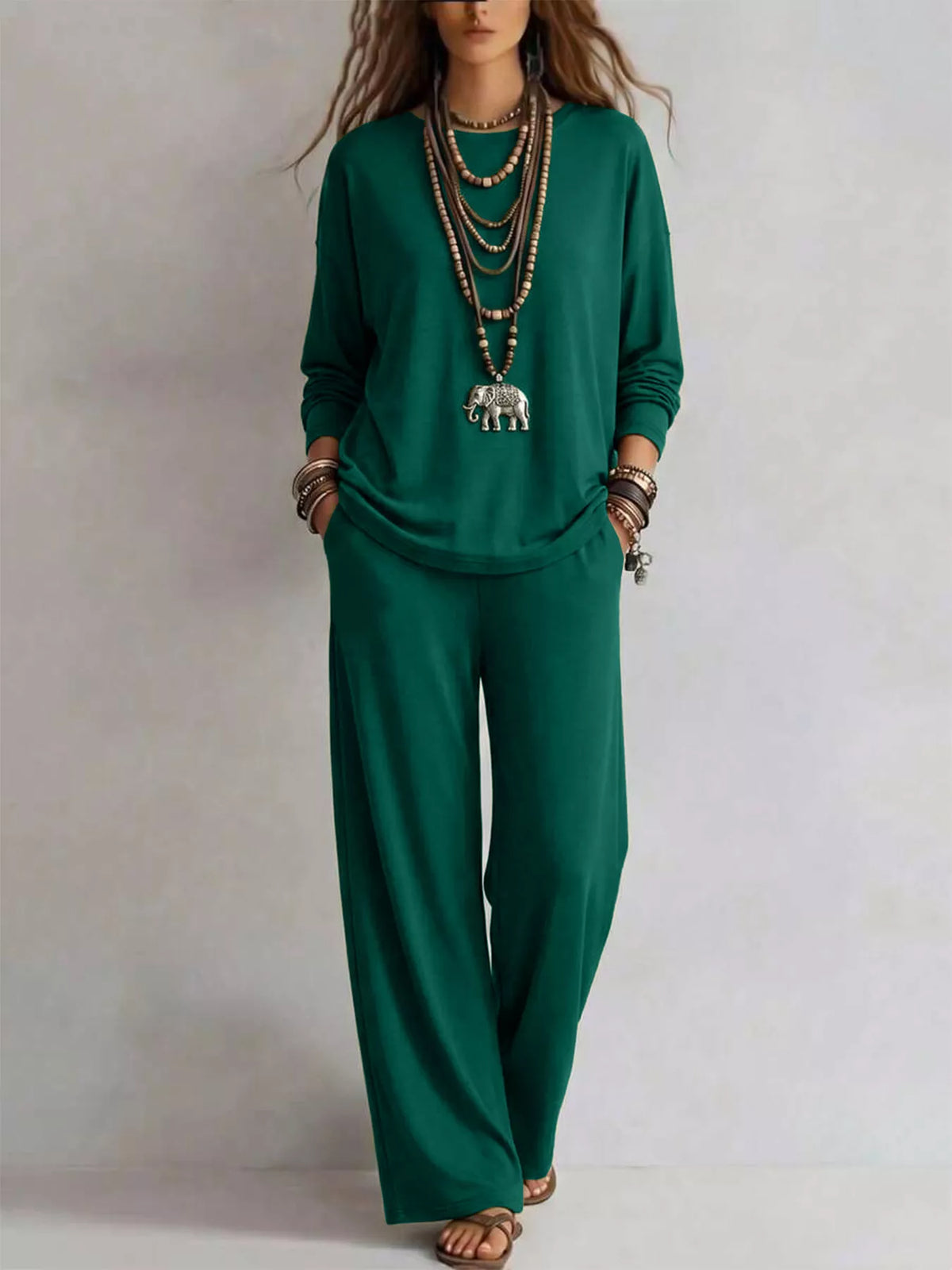 Trendsi round neck T-shirt and wide-leg pants set, featuring a casual fit and neutral color, displayed on a hanger against a white background.