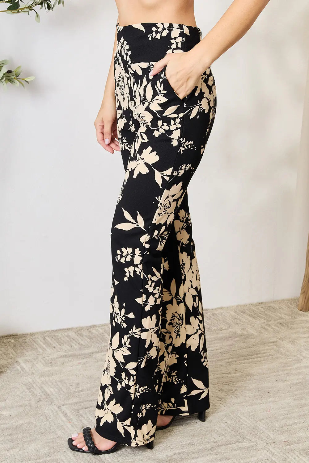 Plus size Heimish floral high waist flare pants with a full-length design and vibrant floral pattern, styled for a trendy look.