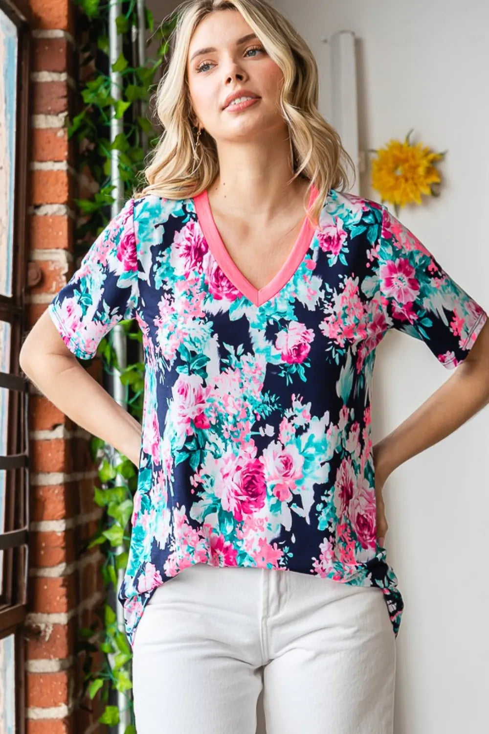 Heimish full size floral V-neck short sleeve T-shirt in white with colorful floral print, designed for a casual, stylish look.